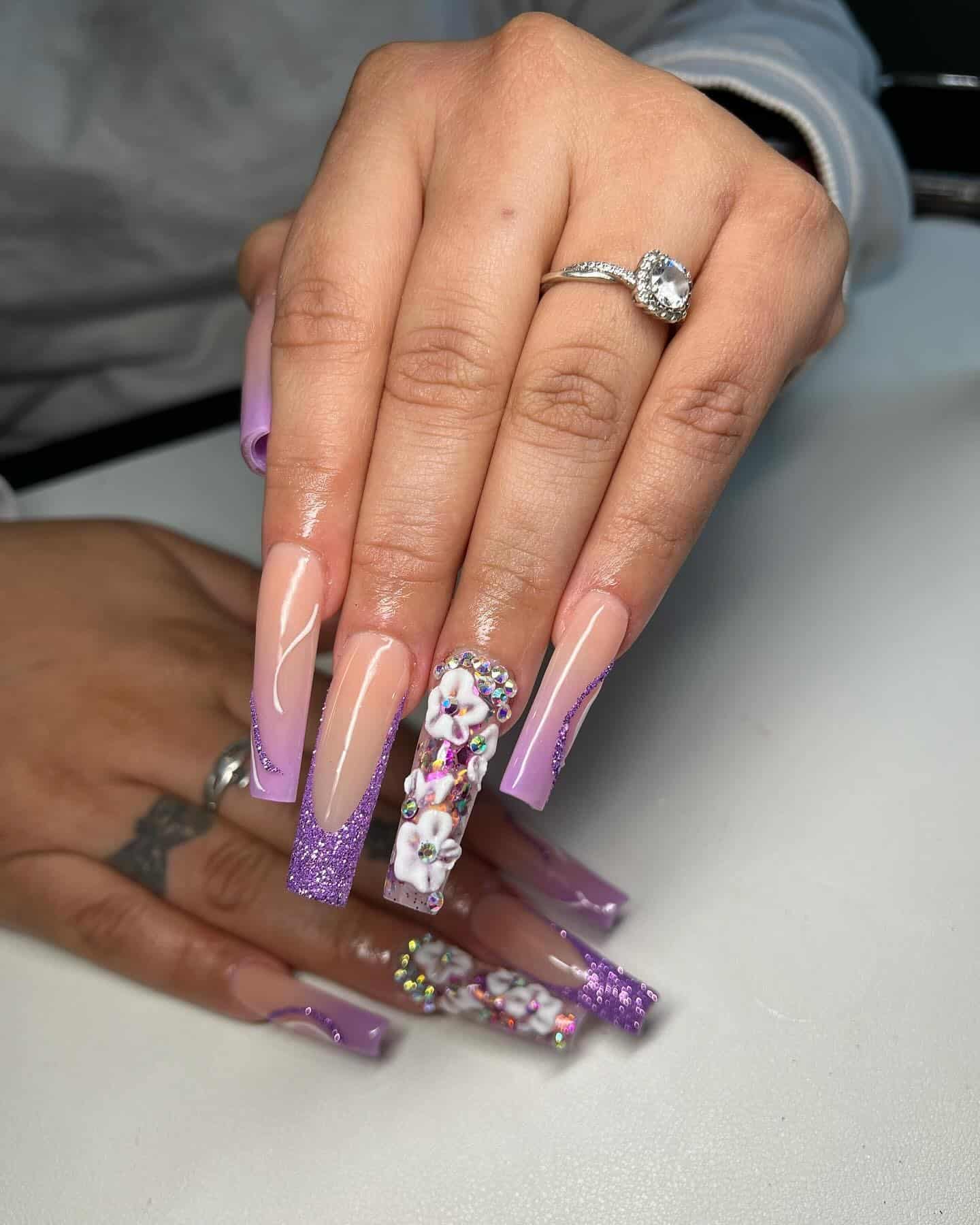 4. Nude Coffin Nails with Purple Glitter and 3D Floral Art - purple coffin nail ideas