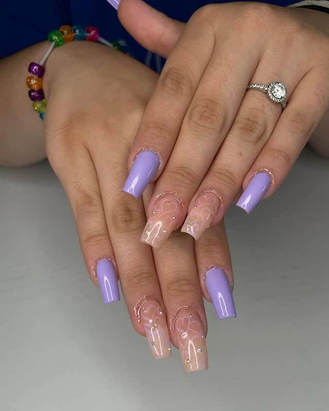 18. Lavender Coffin Nails with Nude Marble Accent Design - purple coffin nail ideas