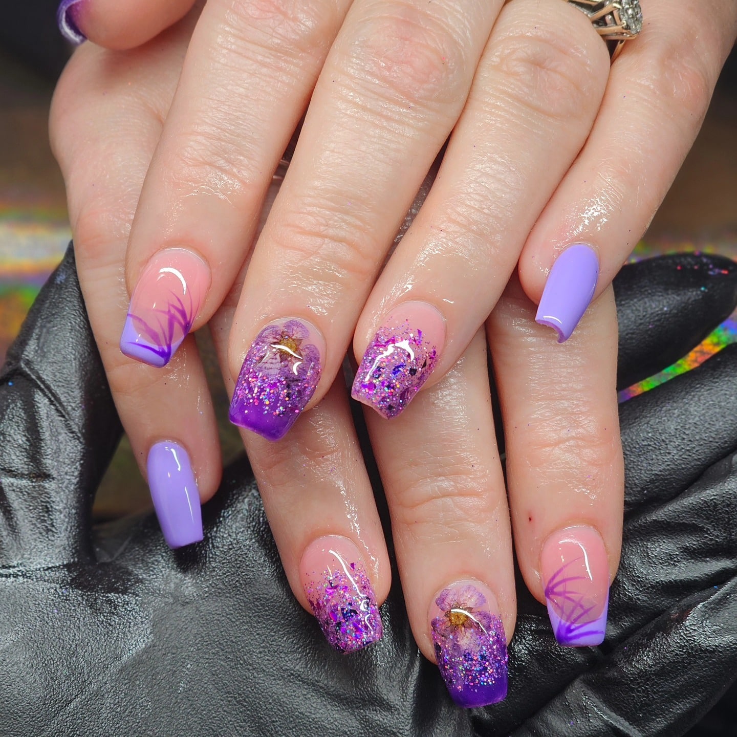 19. Purple Glitter Floral Coffin Nails with Encapsulated Design - purple coffin nail ideas