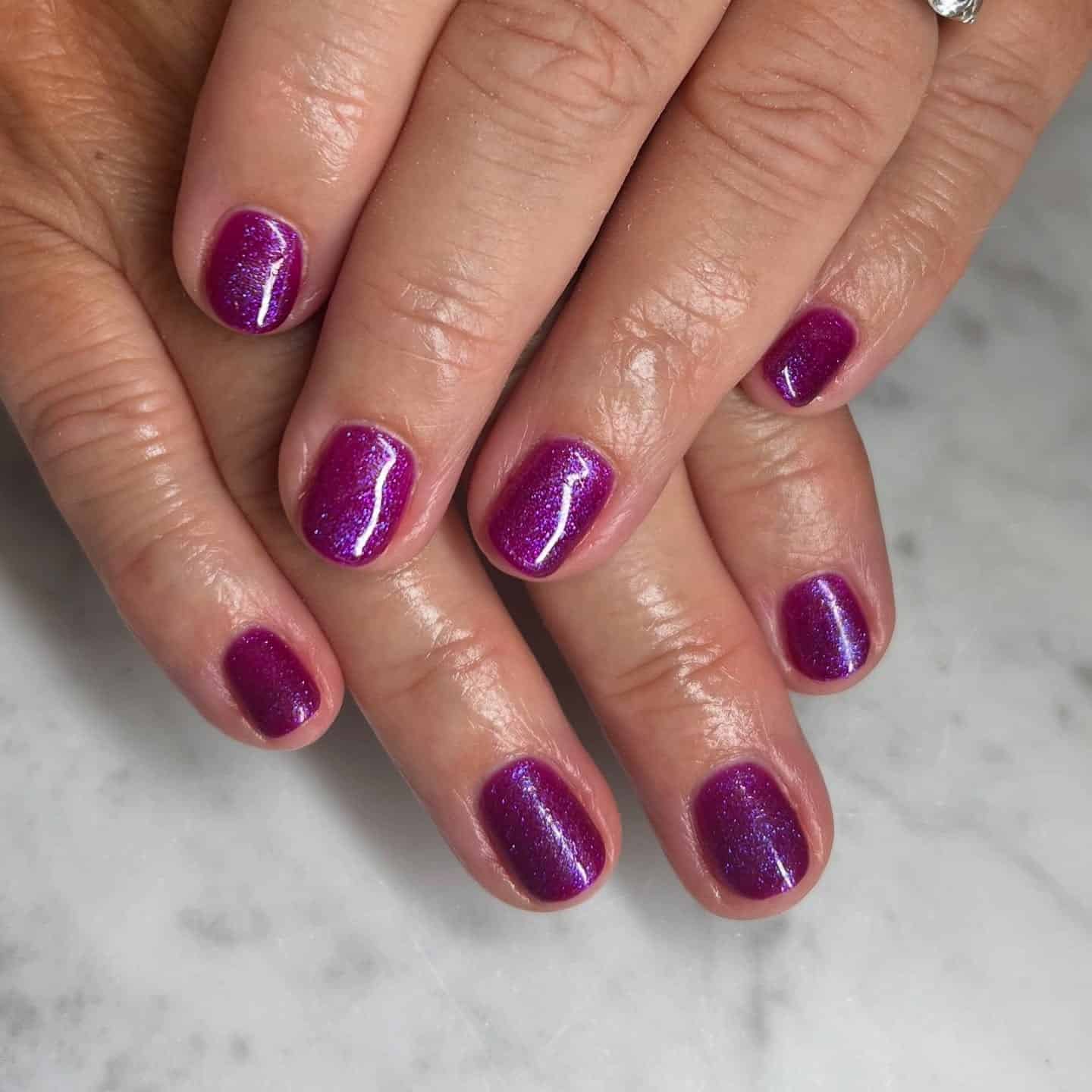 5. Plum Glitter Short Gel Nails - purple glitter nail ideas