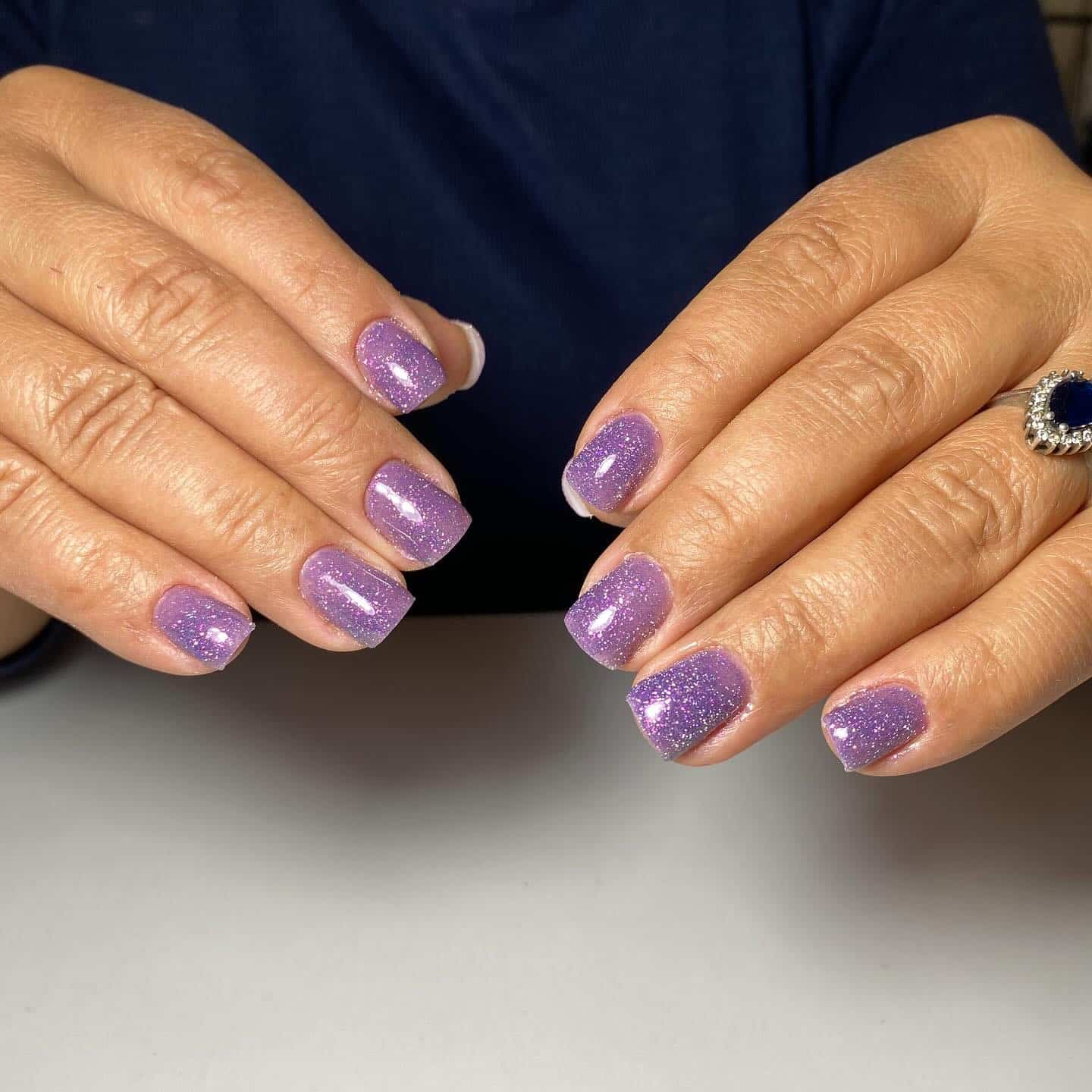 8. Lilac Sparkle Short Square Nails - purple glitter nail ideas