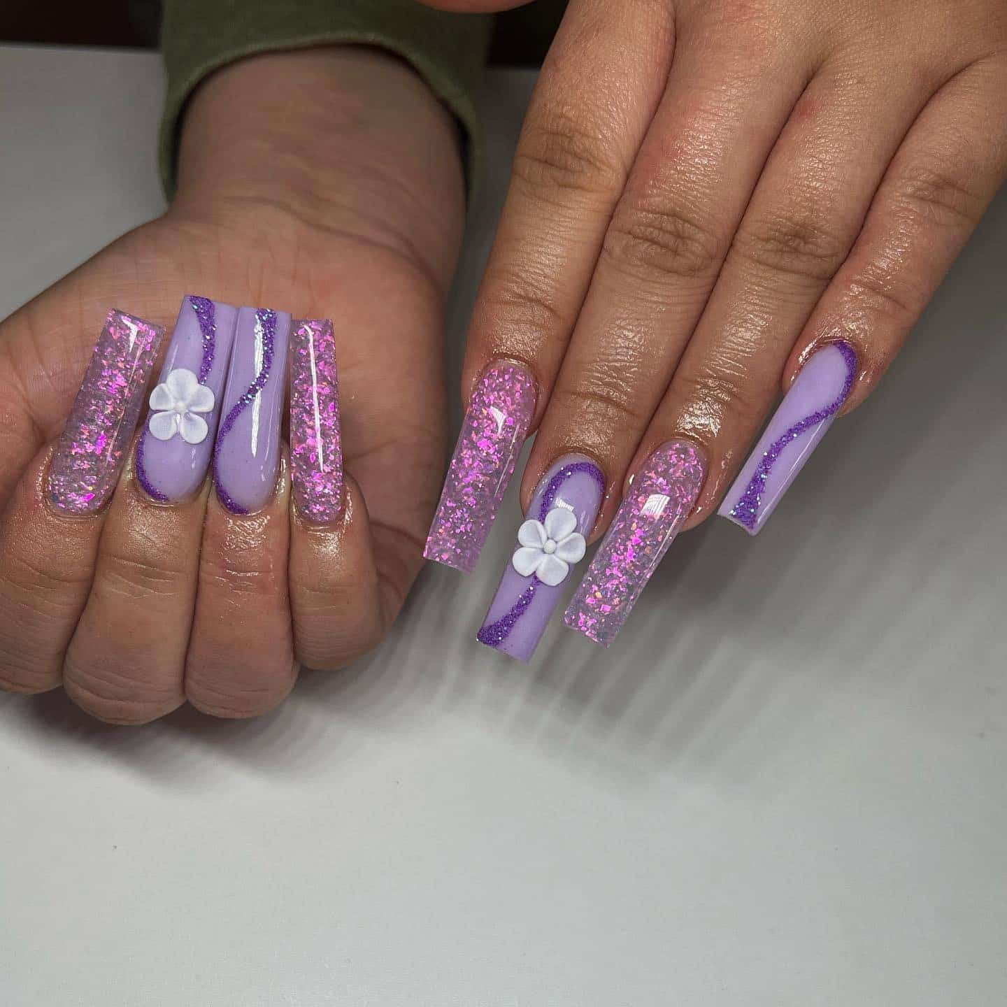 10. Lavender and Pink Glitter Coffin Nails with Floral Accent - purple glitter nail ideas