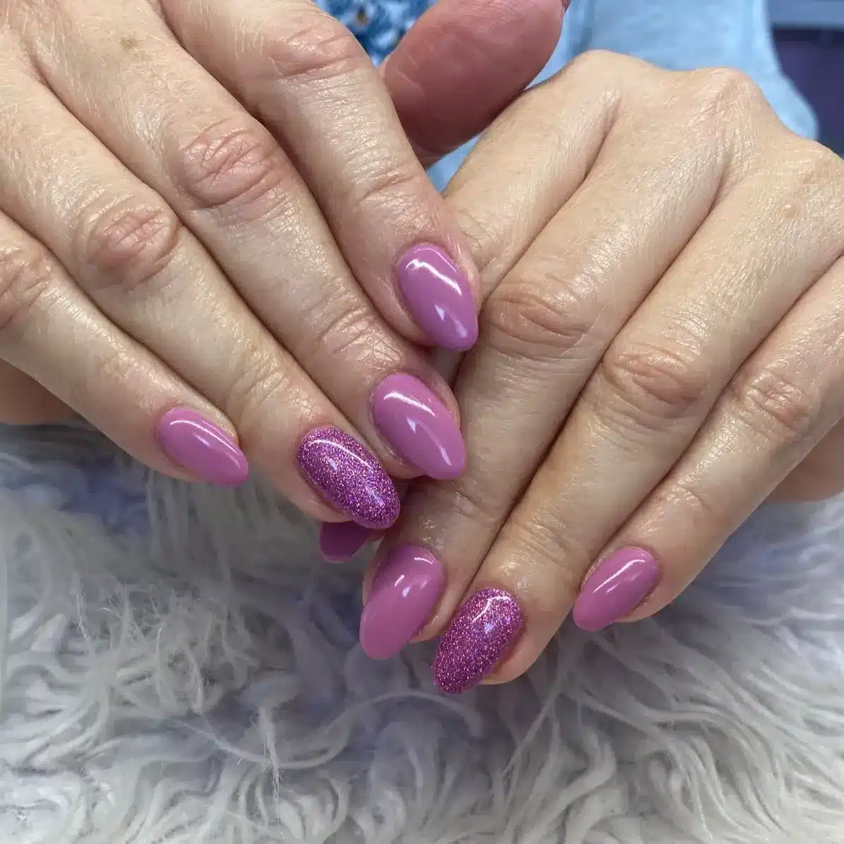 13. Mauve Pink Almond Nails with Glitter Accent - purple glitter nail ideas