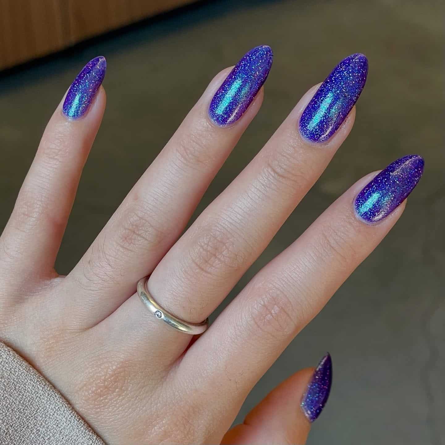 14. Electric Violet Glitter Almond Nails with Chrome Reflection - purple glitter nail ideas