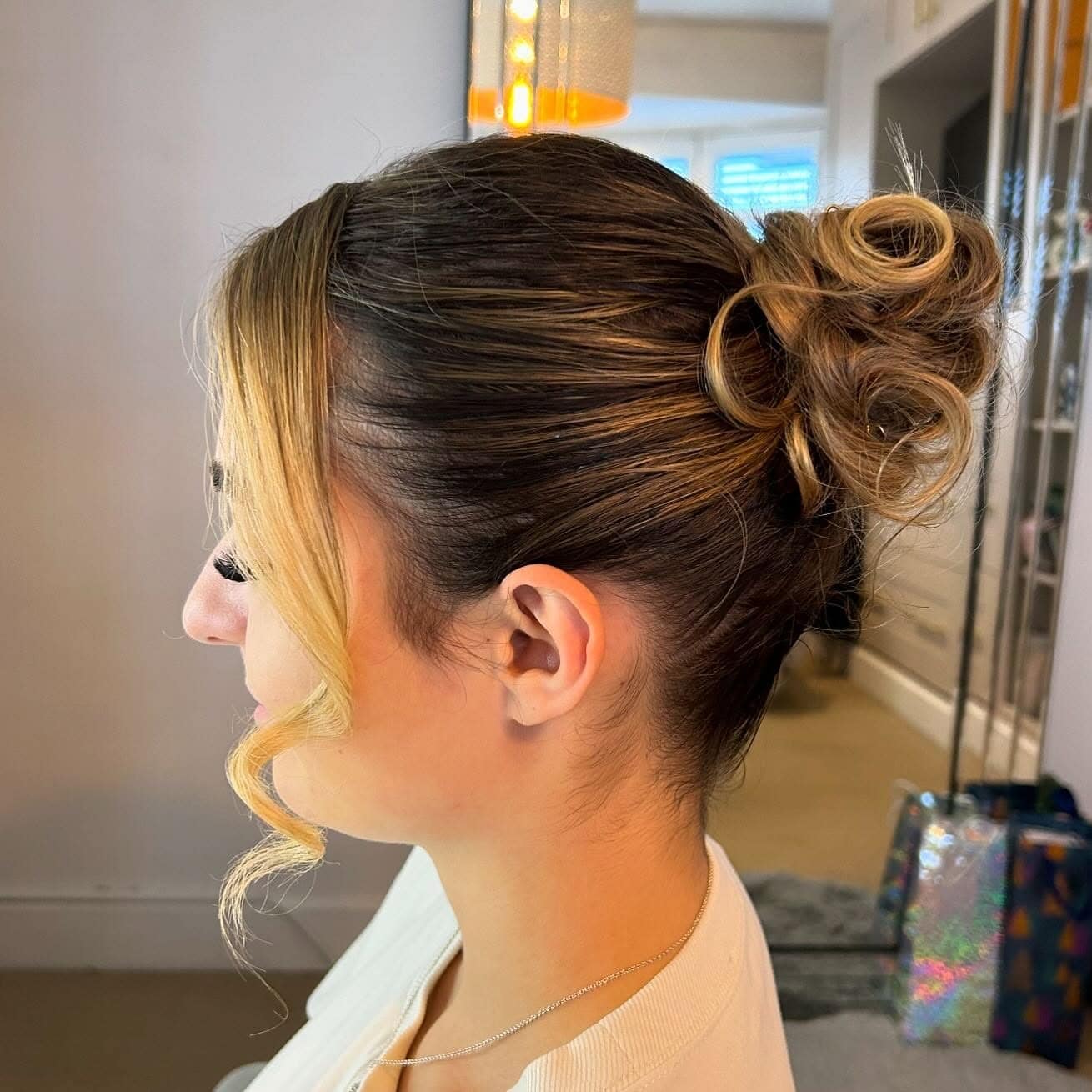 5. Curled Bun with Honey Brown Highlights - Slick Back Hairstyles