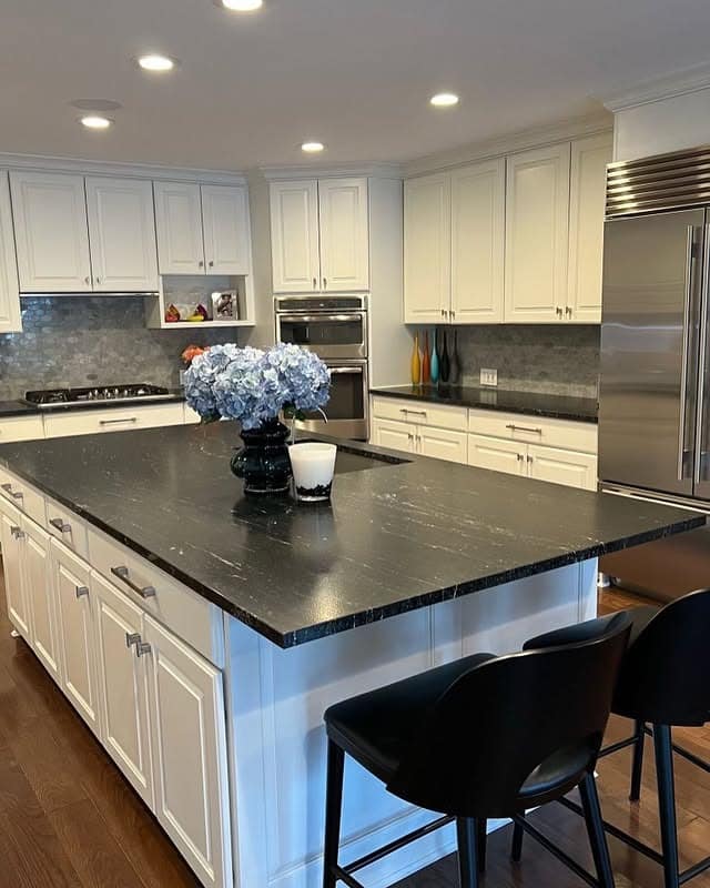 2. Classic White Kitchen with Black Stone Island - white and black kitchen ideas