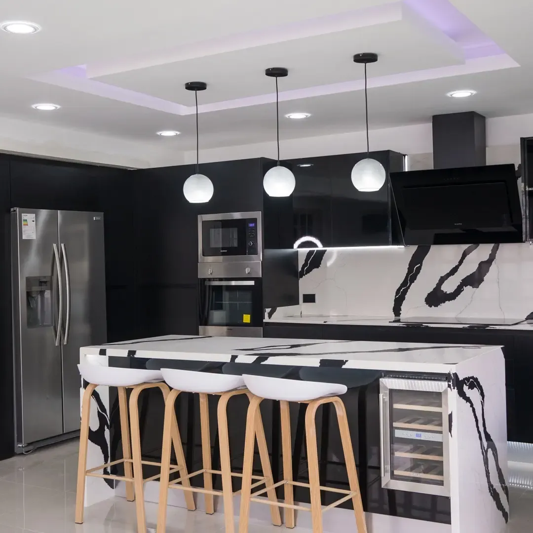 4. High-Gloss Black Kitchen with Marble Statement Surfaces - white and black kitchen ideas