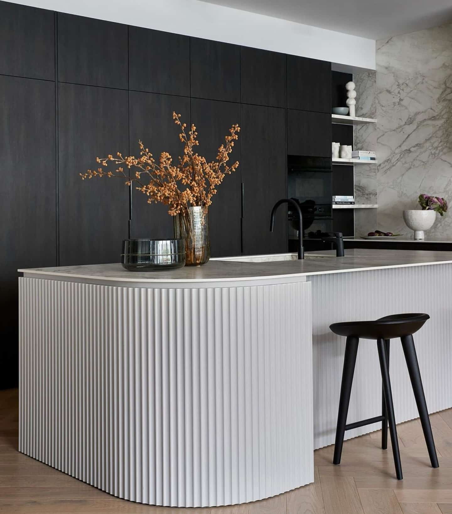 15. Minimal Black and White Kitchen with Fluted Island Detail - white and black kitchen ideas