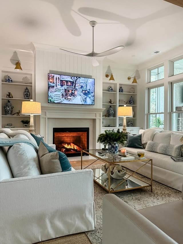 4. Coastal-Inspired Living Room with White Fireplace and Soft Blues - living room ideas with fireplace