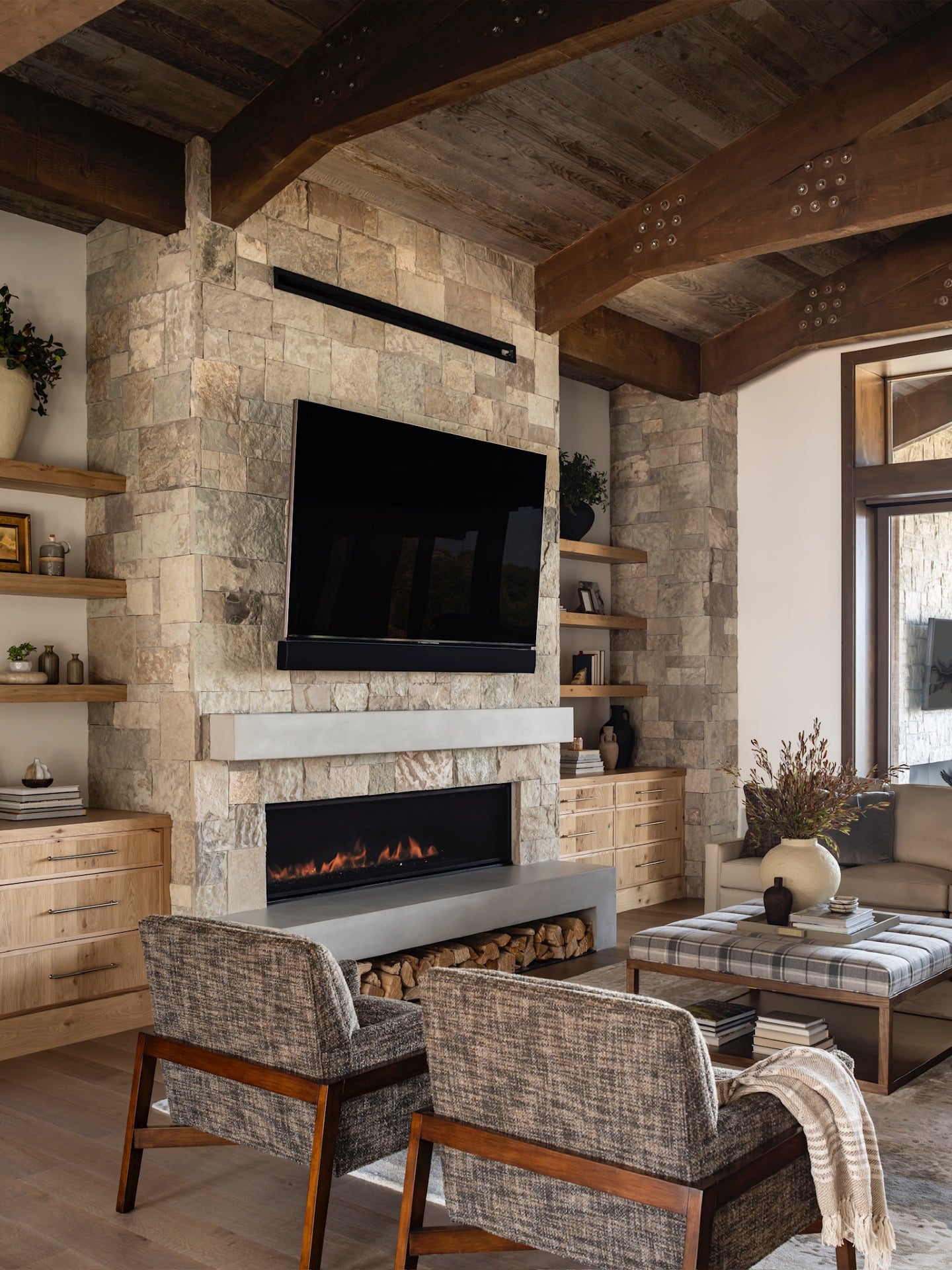 5. Rustic Modern Living Room with Stone Fireplace and Wood Beams - living room ideas with fireplace