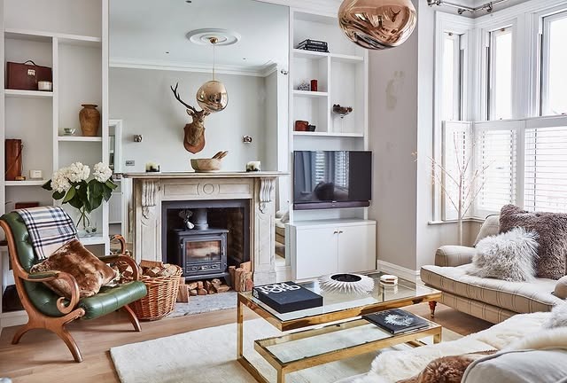 6. Classic English-Inspired Living Room with Ornate Fireplace - living room ideas with fireplace