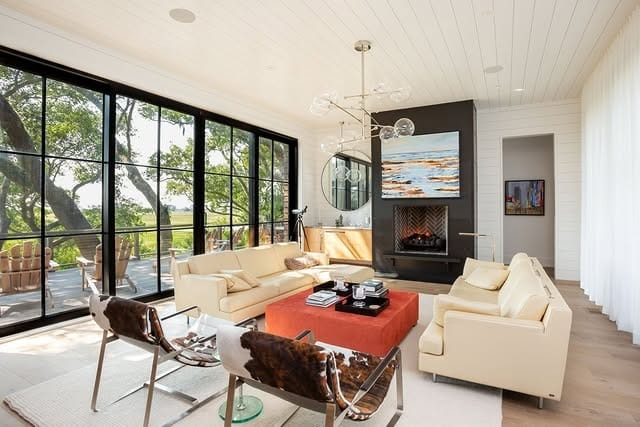 9. Modern Open-Concept Living Room with Black Accent Fireplace - living room ideas with fireplace