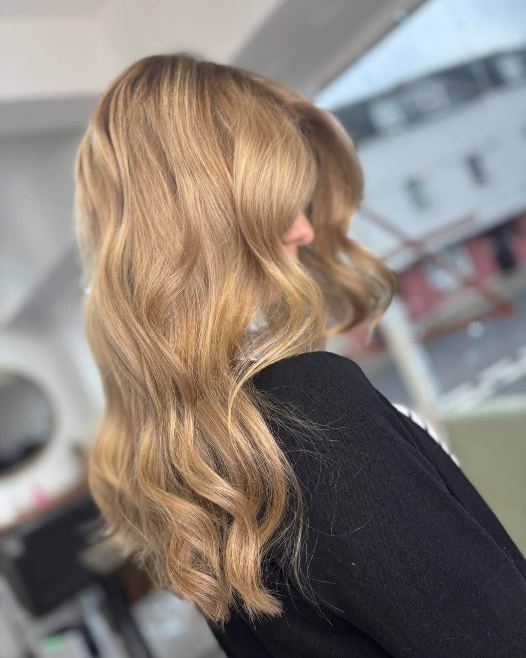 20. Warm Sandy Blonde with Polished Waves - Warm Blonde Hair Color