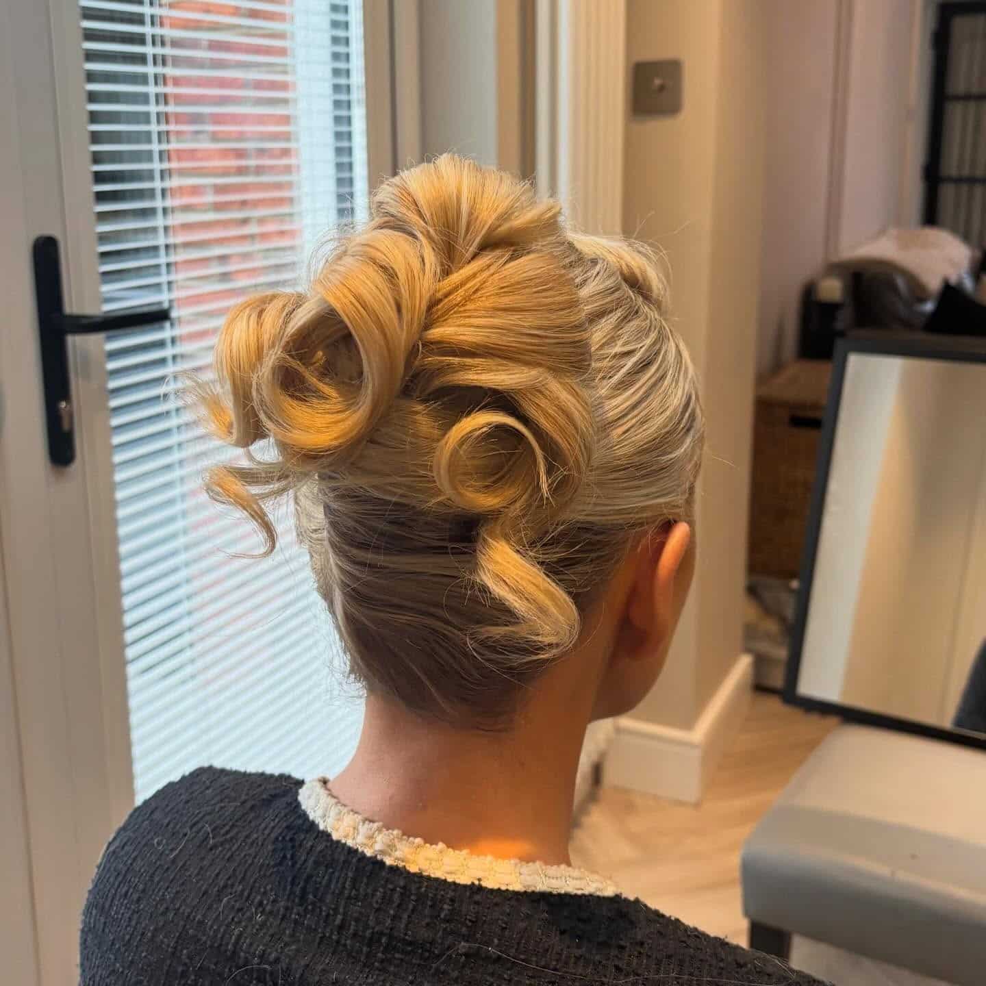 10. Blonde Sculpted Loop Updo with Defined Curls - Updo Hairstyles