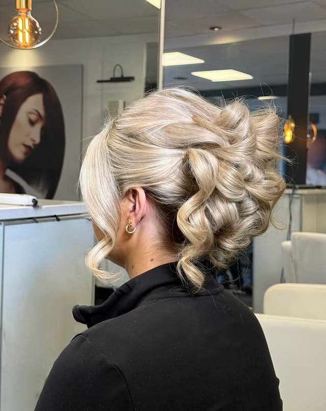 11. Textured Platinum Blonde Low Updo with Soft Loops - Updo Hairstyles