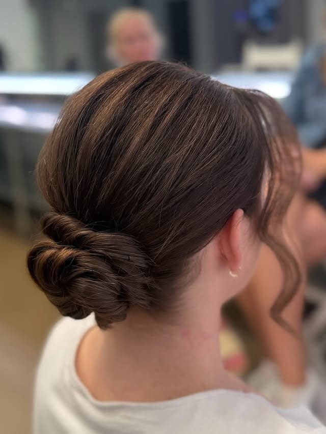 12. Sleek Chestnut Brown Twisted Low Bun - Updo Hairstyles