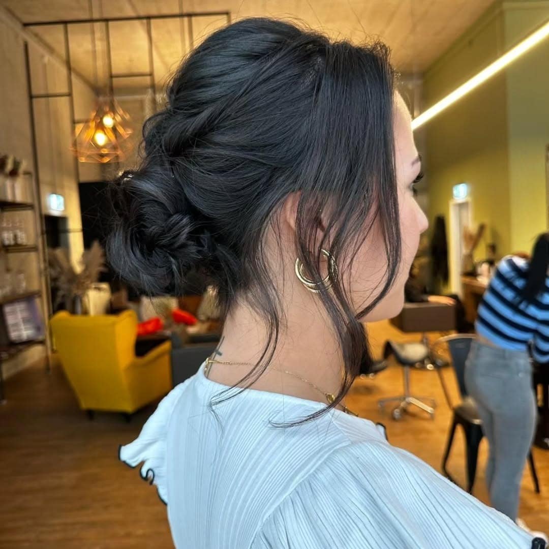 21. Soft Black Textured Low Updo with Face-Framing Waves - Updo Hairstyles