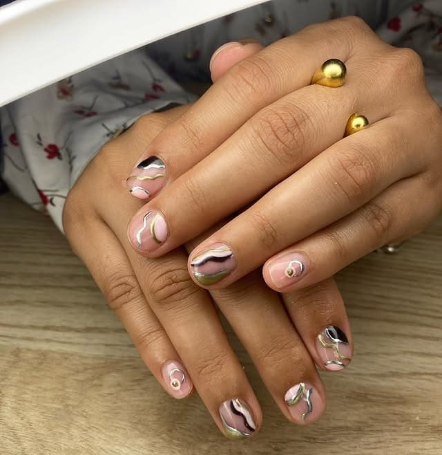 8. Nude Almond Nails with Gold and Silver Foil Accents - silver and gold nail ideas