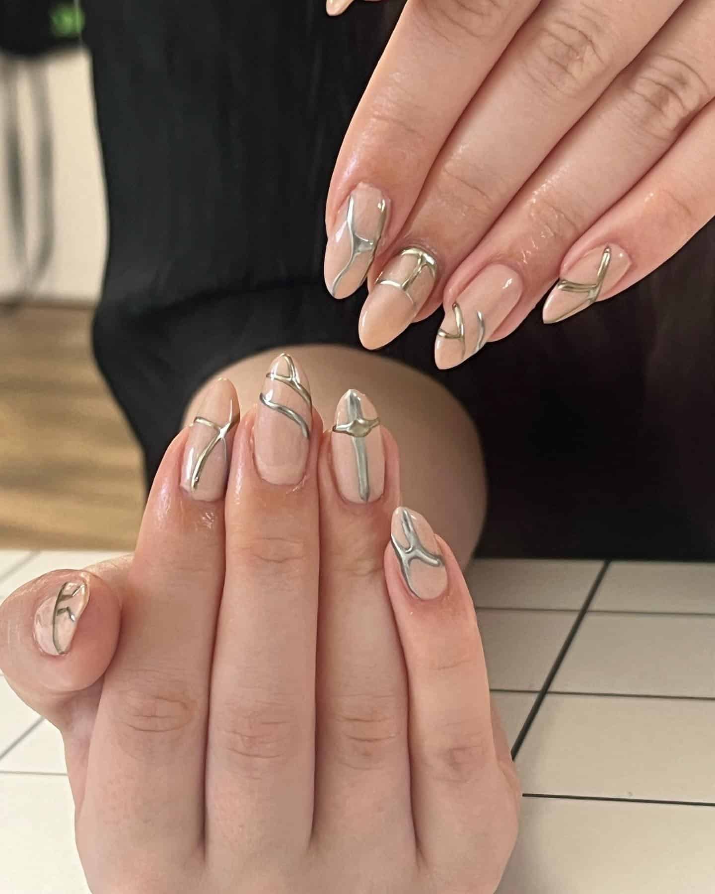 12. Nude Almond Nails with Chrome Silver Line Art - silver and gold nail ideas