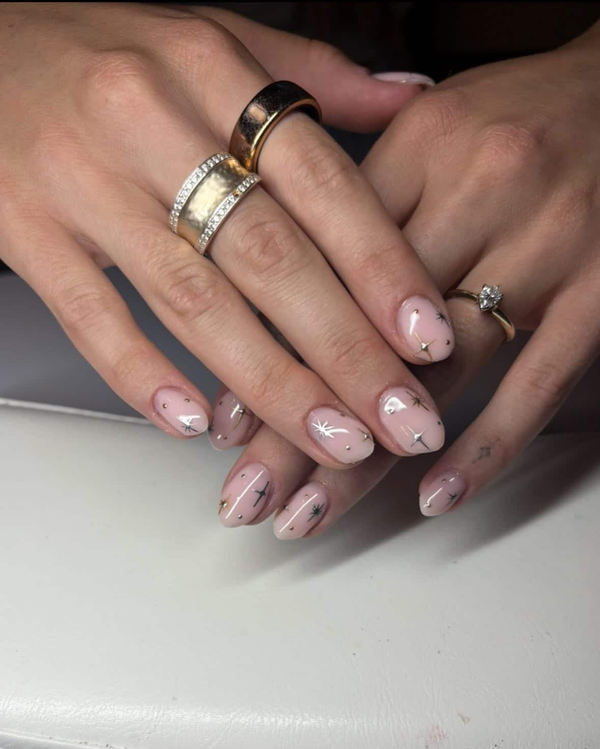 15. Sheer Pink Nails with Gold Starburst and Metallic Accents - silver and gold nail ideas