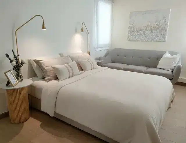 5. Contemporary Beige Bedroom with Compact Sofa Seating - sofa in bedroom ideas