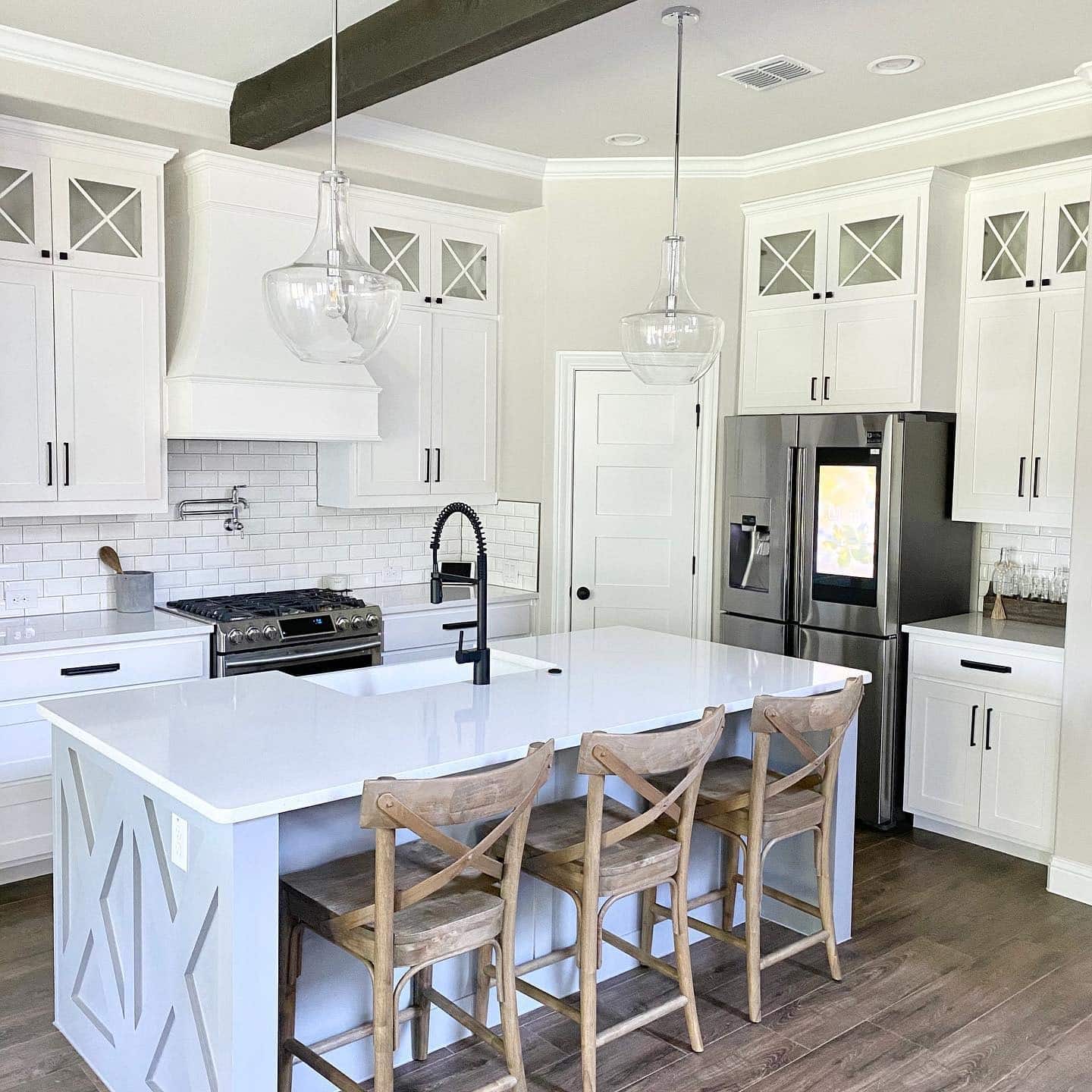 2. Soft White Kitchen with Glass Pendant Accents - farmhouse kitchen island ideas