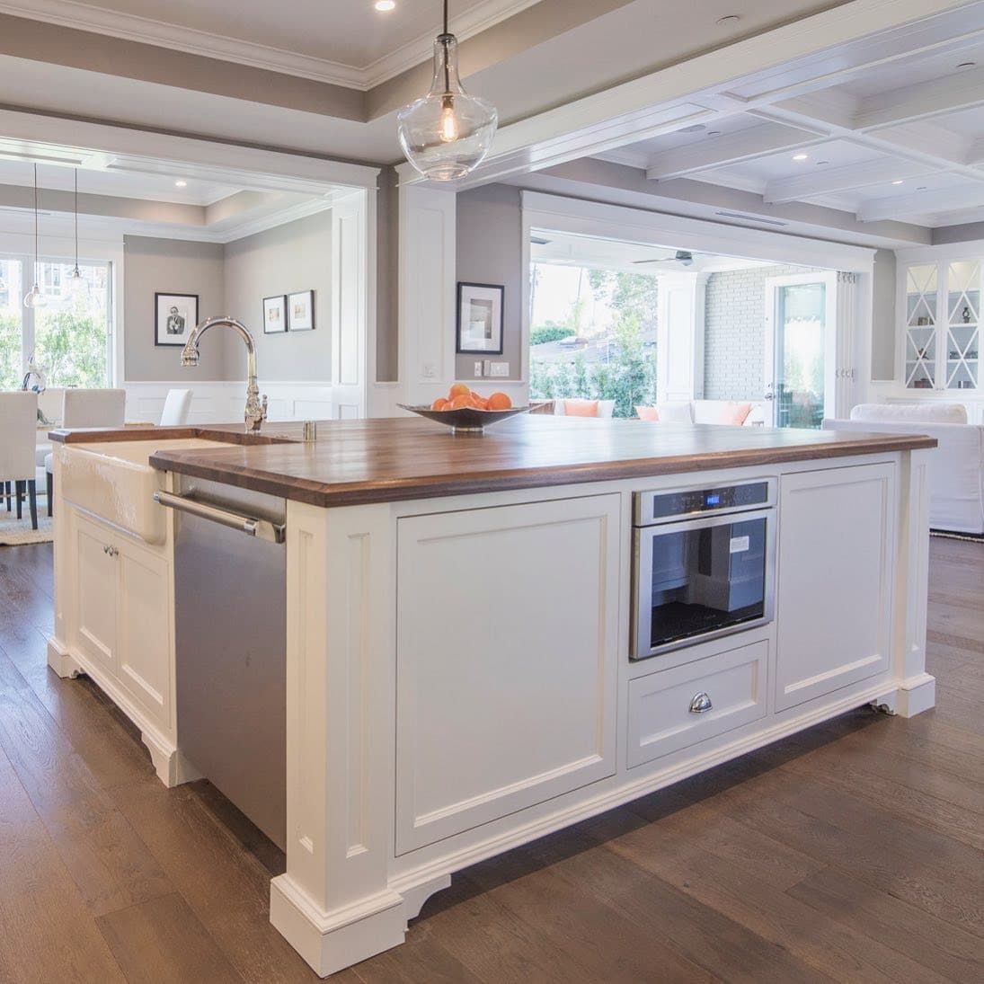 11. White Paneled Island with Warm Wood Countertop - farmhouse kitchen island ideas
