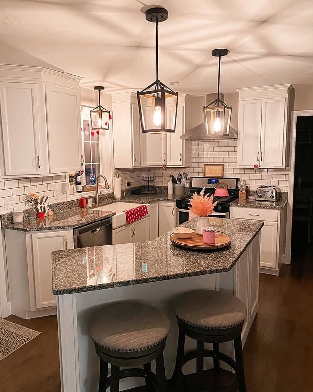 13. White Granite Island with Black Lantern Lighting - farmhouse kitchen island ideas