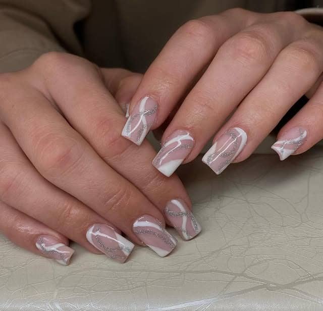 5. Sheer Pink and White Abstract Swirl Nails with Silver Glitter - silver and white nail ideas