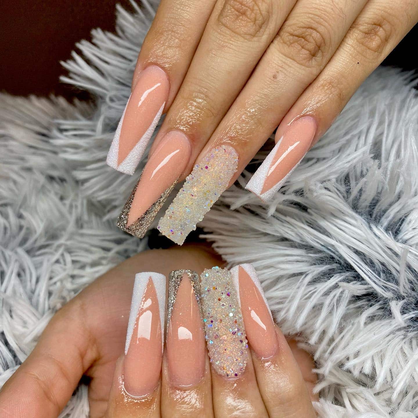 8. Nude Base with White French and Silver Glitter Edging - silver and white nail ideas