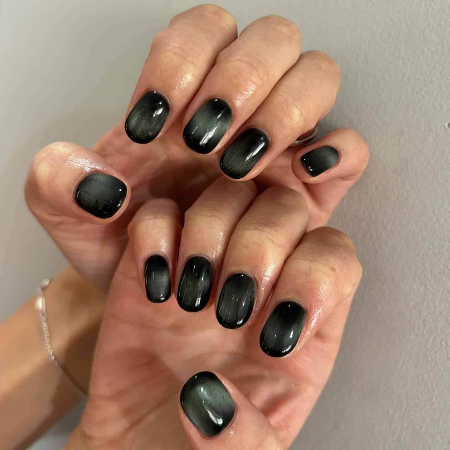 7. Dark Green Cat Eye Oval Nails - simple green nail ideas