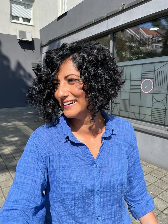 18. Voluminous Curly Bob with Natural Black - Messy Haircut For Women