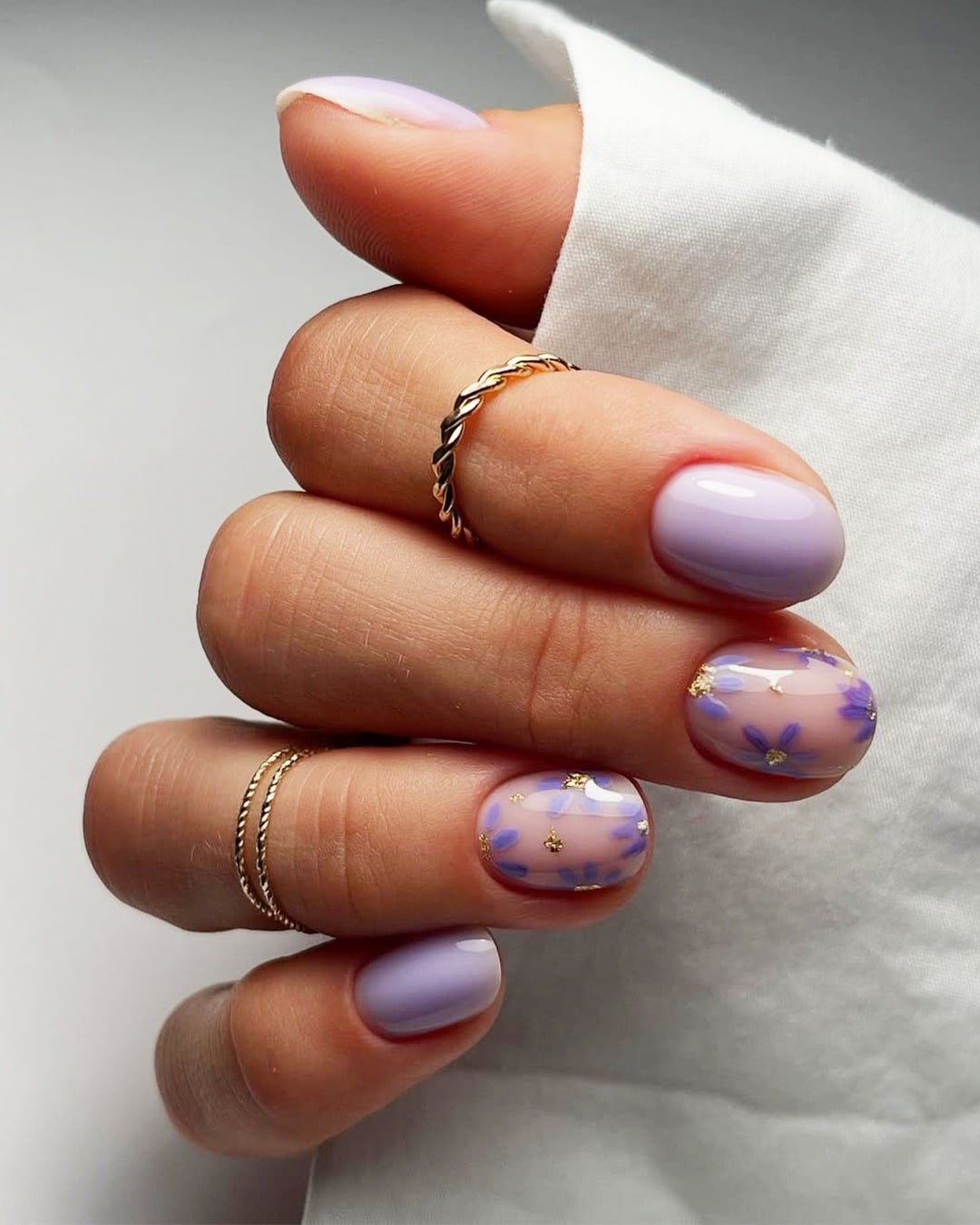 16. Short Lilac Floral Accent Nails with Gold Foil - simple pastel nail ideas