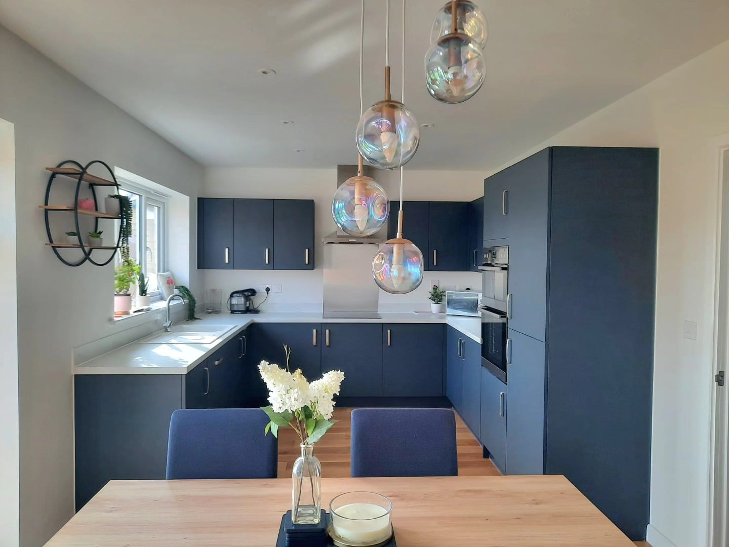 2. Soft Blue Modern Kitchen with Light Wood Details - blue kitchen ideas