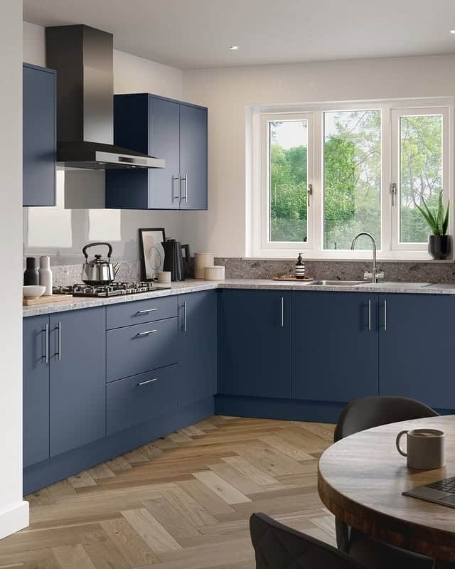 18. Matte Blue Kitchen with Minimalist Layout and Natural Light - blue kitchen ideas