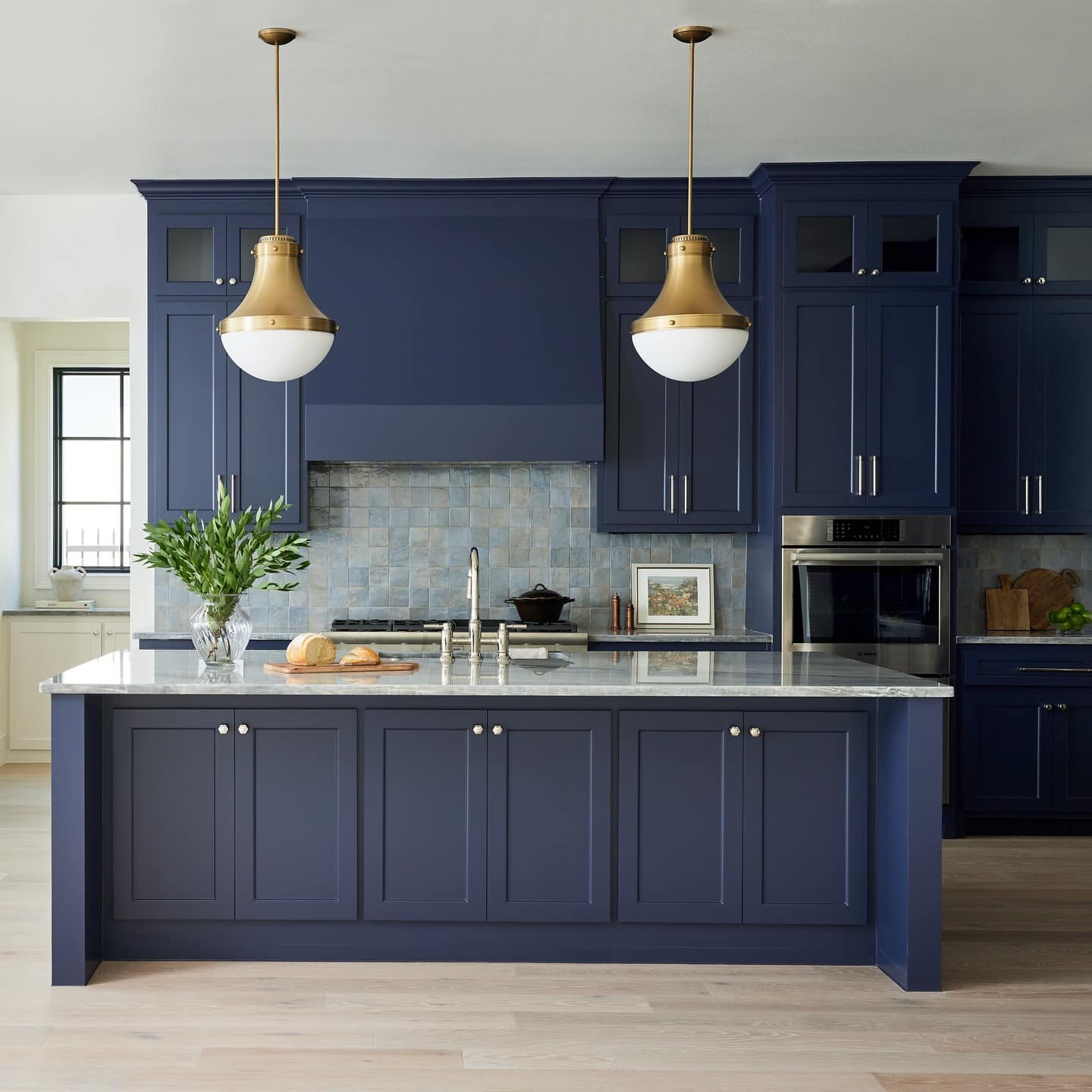 20. Deep Navy Kitchen with Brass Pendant Lighting and Island Focus - blue kitchen ideas