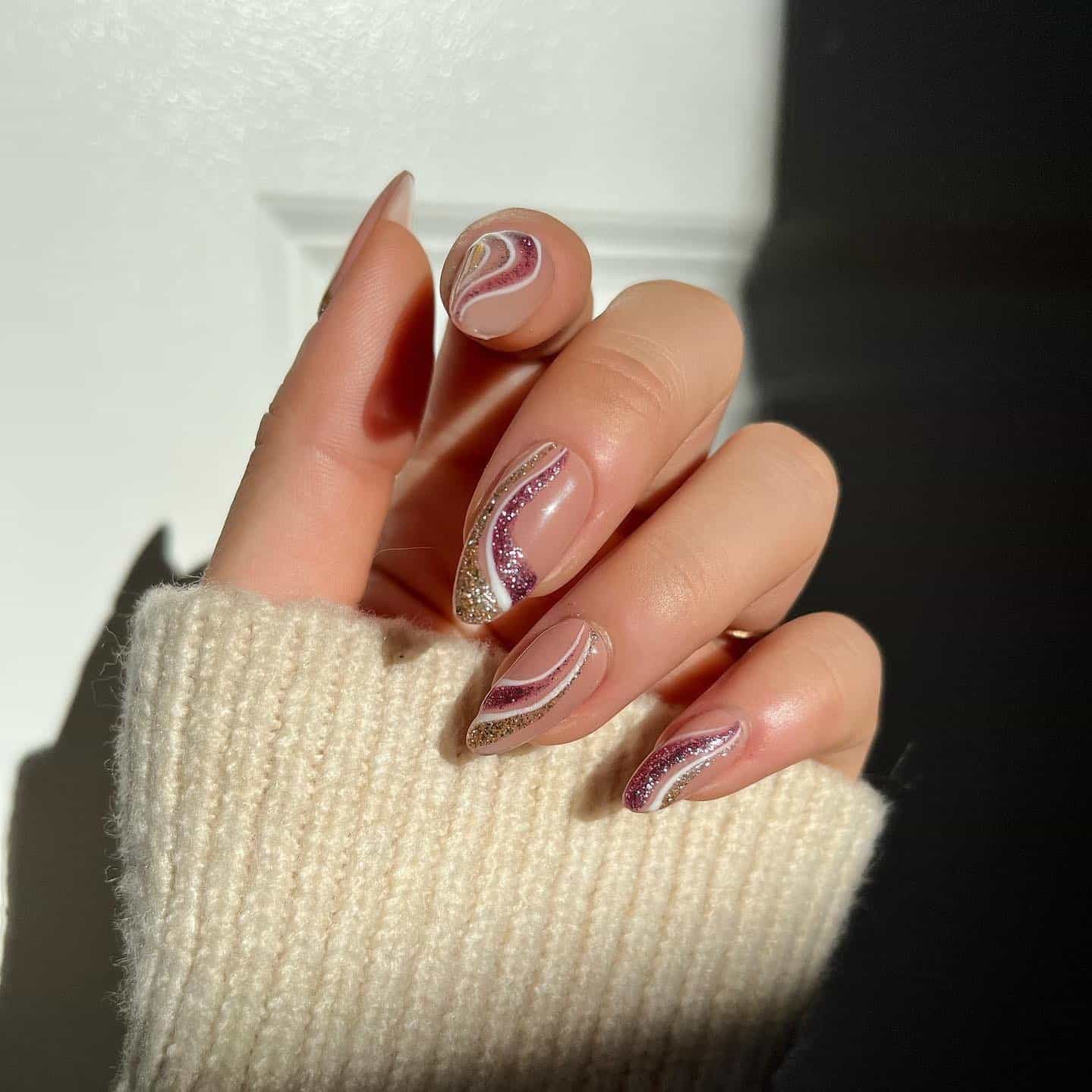 16. Almond Nude Nails with Rose and Gold Glitter Waves - simple sparkly nail ideas