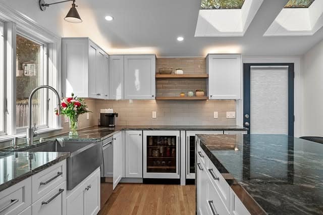 15. Soft Gray U-Shaped Kitchen with Skylight Accents - long kitchen ideas