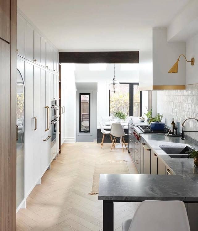 19. Contemporary Long Kitchen with Mixed Materials and Brass Lighting - long kitchen ideas