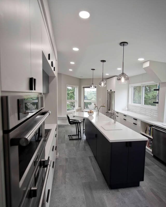 20. Modern Two-Tone Kitchen with Dark Island and Linear Lighting - long kitchen ideas
