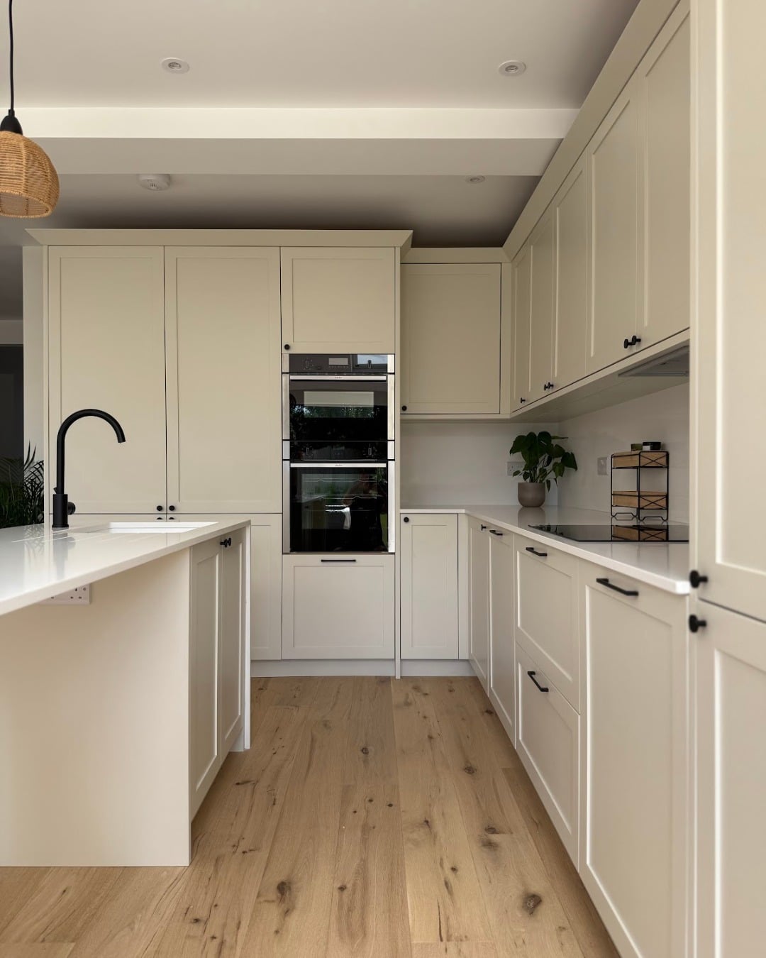 21. Soft Cream U-Shaped Kitchen with Natural Wood Flooring - long kitchen ideas