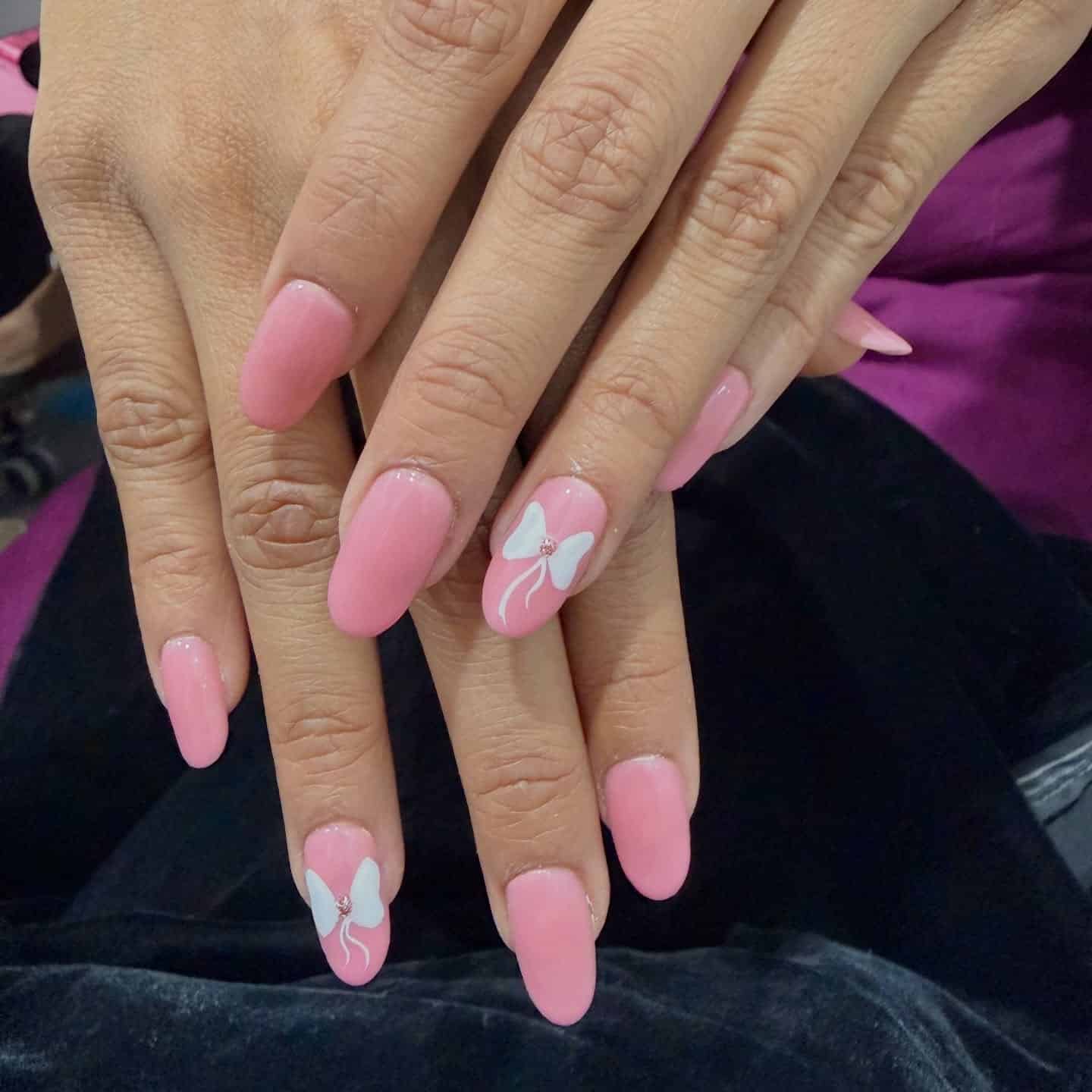 16. Pink Oval Nails with White Bow Accent - soft pink nail ideas