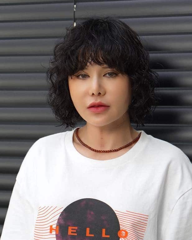 3. Soft Curly Shag with Wispy Fringe in Dark Brown - Hippie Haircuts