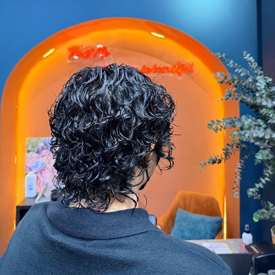 11. Short Curly Shag in Glossy Black - Hippie Haircuts