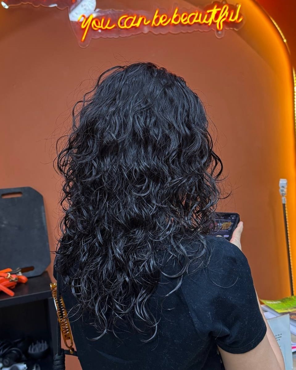 15. Long Curly Shag with Layered Texture in Natural Black - Hippie Haircuts