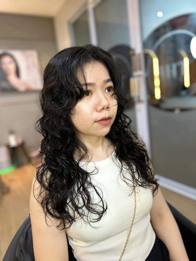 19. Soft Curly Layers with Curtain Fringe in Dark Brown - Hippie Haircuts