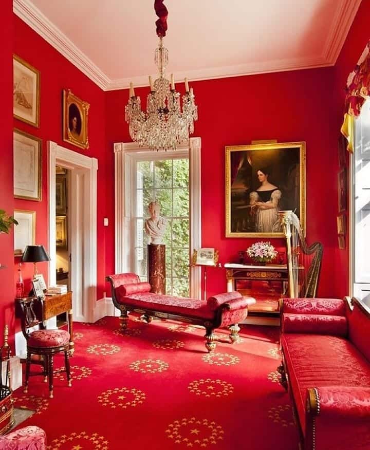 7. Elegant Red Drawing Room with Traditional Details - red living room ideas