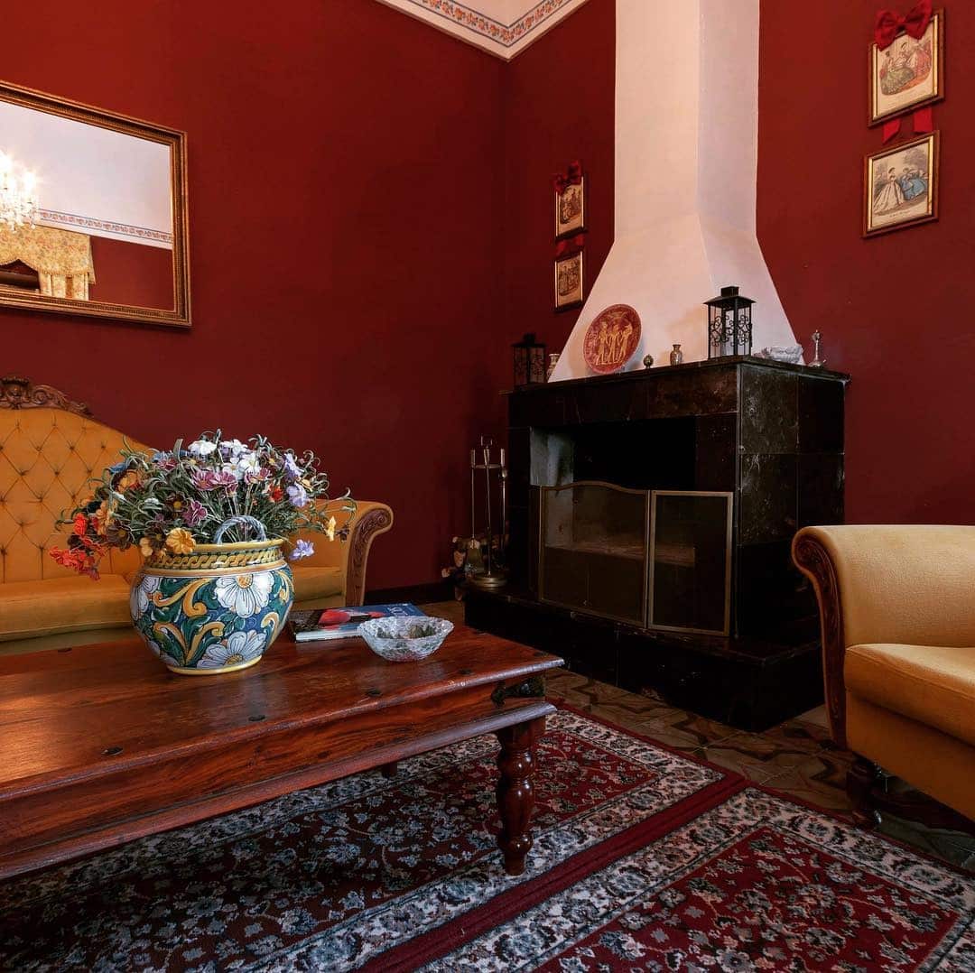 14. Rustic Red Living Room with Mediterranean Warmth - red living room ideas