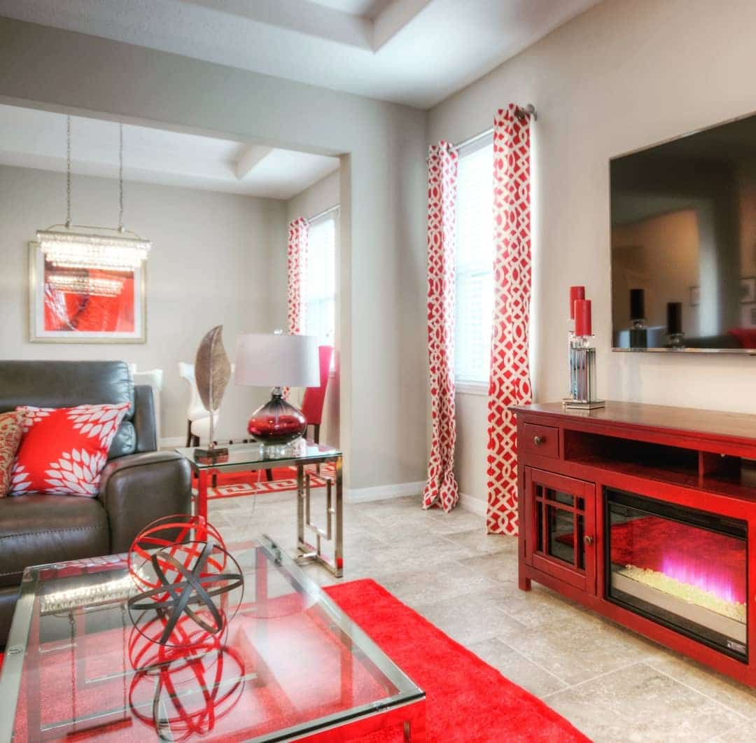 15. Soft Neutral Living Room with Red Accents and Patterned Textiles - red living room ideas