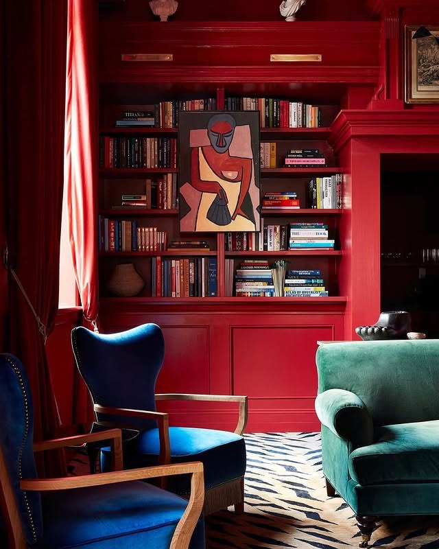 16. Eclectic Red Library Living Room with Bold Color Pairings - red living room ideas